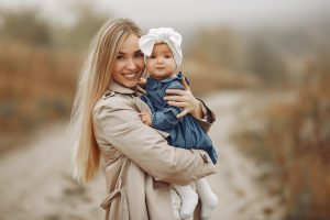 mother-with-daughter-playing-autumn-field_1157-34988