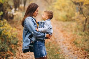 mother-with-her-little-son-autumn-park_1303-11726